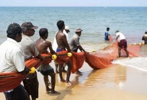 Travel in Asia - A group of fishermen in Sri Lanka doing traditional beach seine fishing