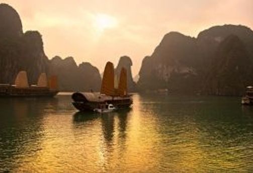 Travel in Asia - Boats floating at sunset in Hạ Long Bay, Vietnam