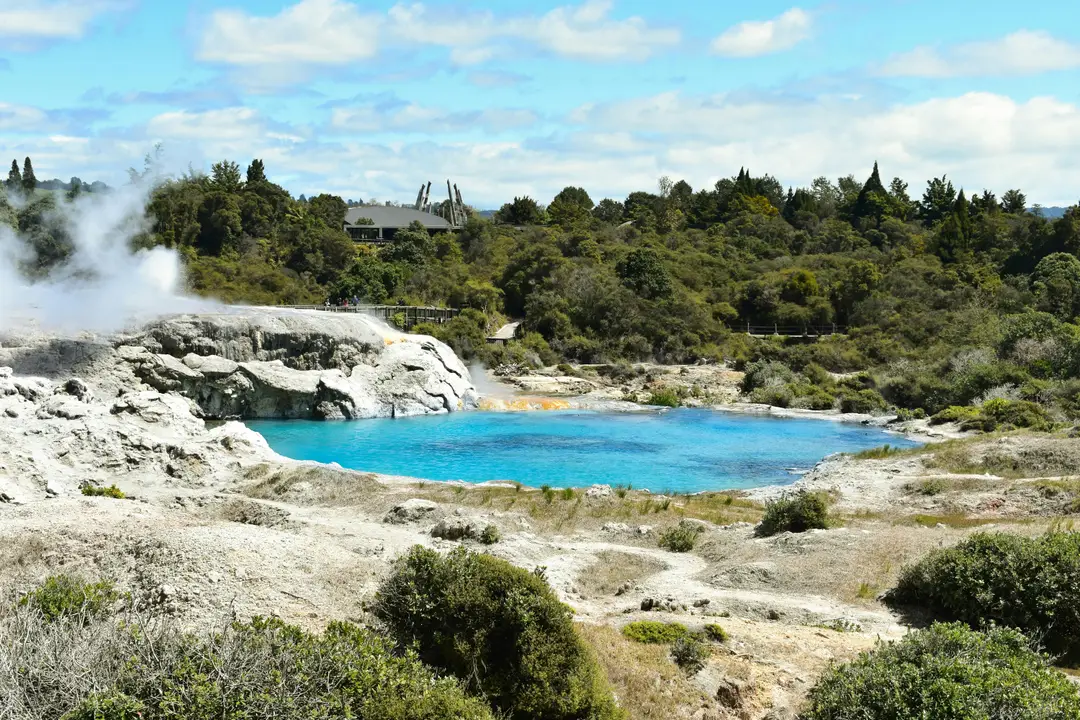Bassin géothermique bleu turquoise et fumerolles de vapeur dans le paysage volcanique de Rotorua, Nouvelle-Zélande