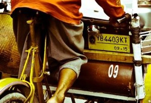 Travel in Asia - A person driving an Indonesian cycle rickshaw