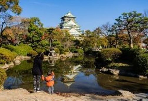 Voyage en Asie — Famille visitant le château d’Osaka au Japon lors d’un voyage avec enfants