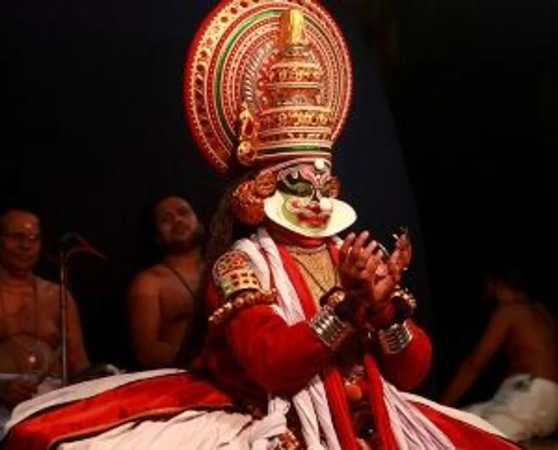 Travel in Asia - A person performing in Kathakali, a classical dance-drama from Kerala, India