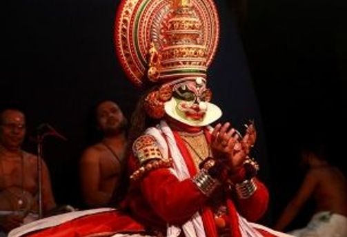Travel in Asia - A person performing in Kathakali, a classical dance-drama from Kerala, India