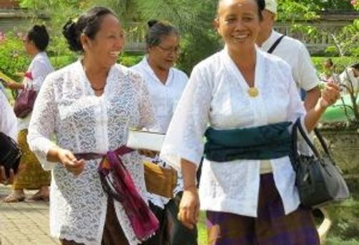 Travel in Asia - Women walking and smiling in a street of a city in Indonesia