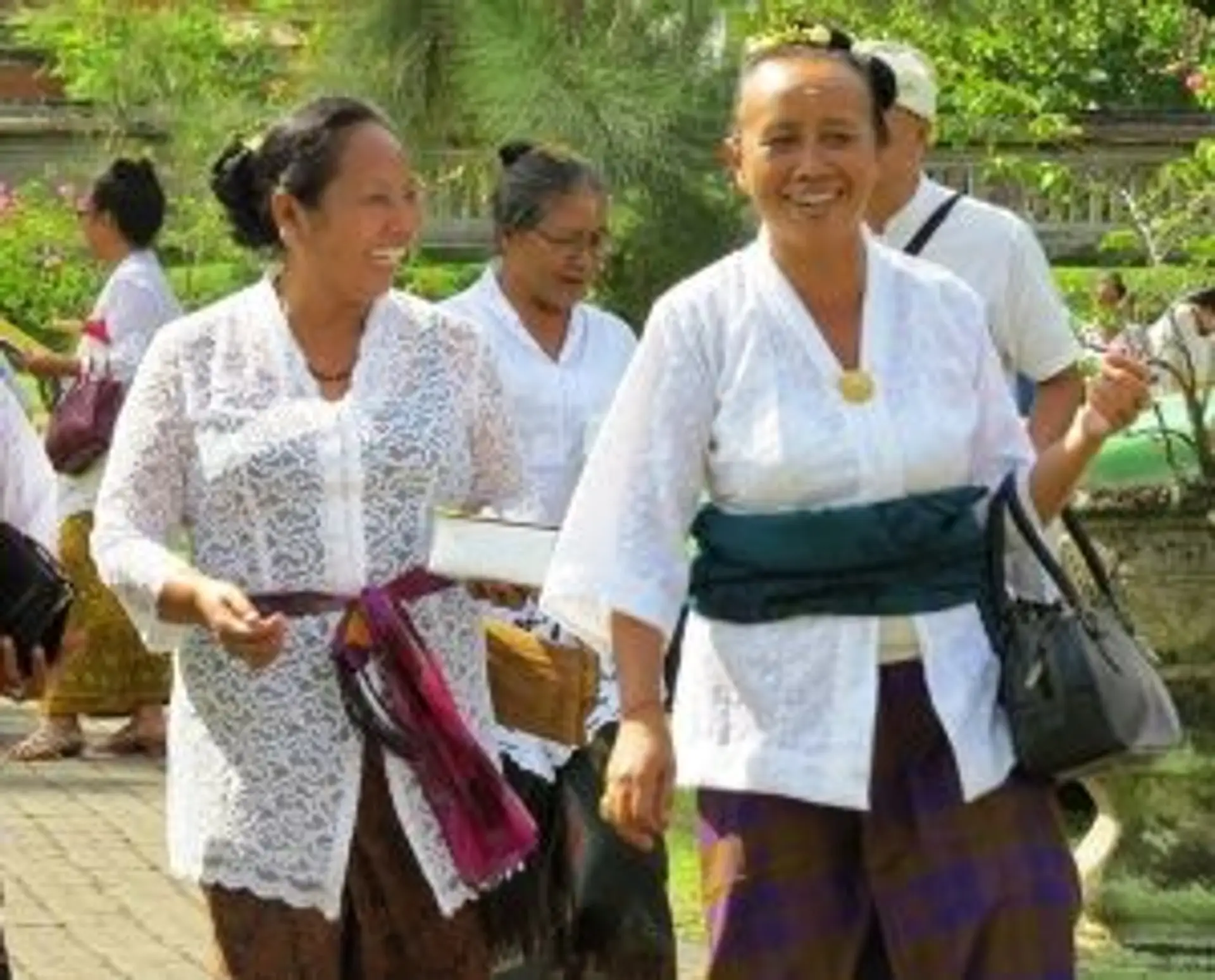 Travel in Asia - Women walking and smiling in a street of a city in Indonesia