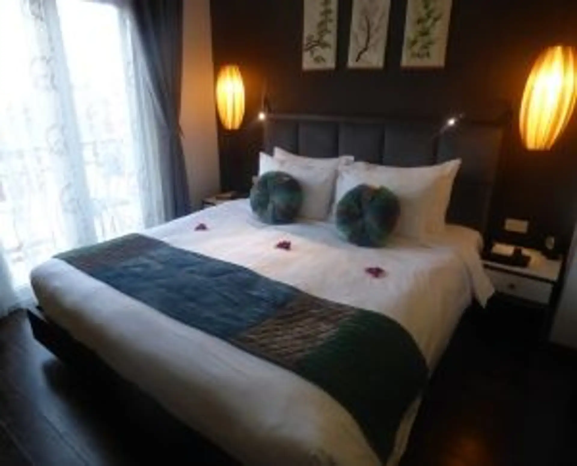 Travel in Asia - A king-sized bed adorned with decorative pillows and a runner in a modern hotel room