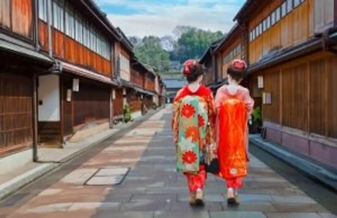 Travel in Asia - Two women wearing traditional kimono walking down a quiet street in the historic Higashi Chaya District of Kanazawa, Japan