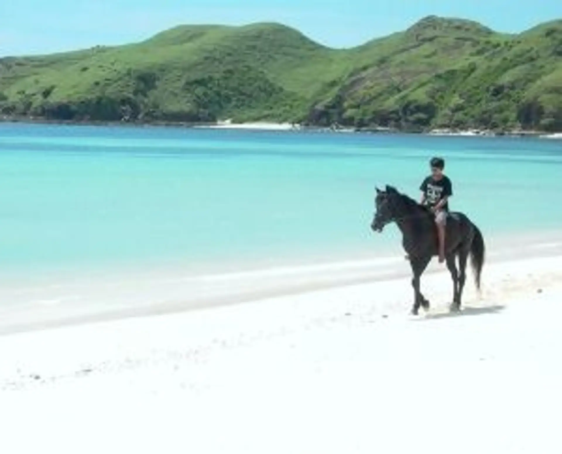 Travel in Asia - A person riding a horse on Tanjung Aan Beach in Lombok, Indonesia