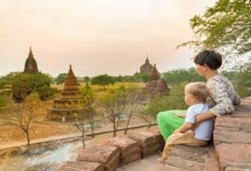 Travel in Asia - A mother and child viewing the sunset over the ancient city of Bagan, Myanmar.