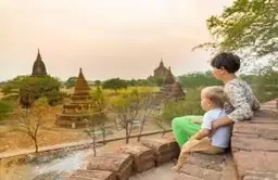 Travel in Asia - A mother and child viewing the sunset over the ancient city of Bagan, Myanmar.