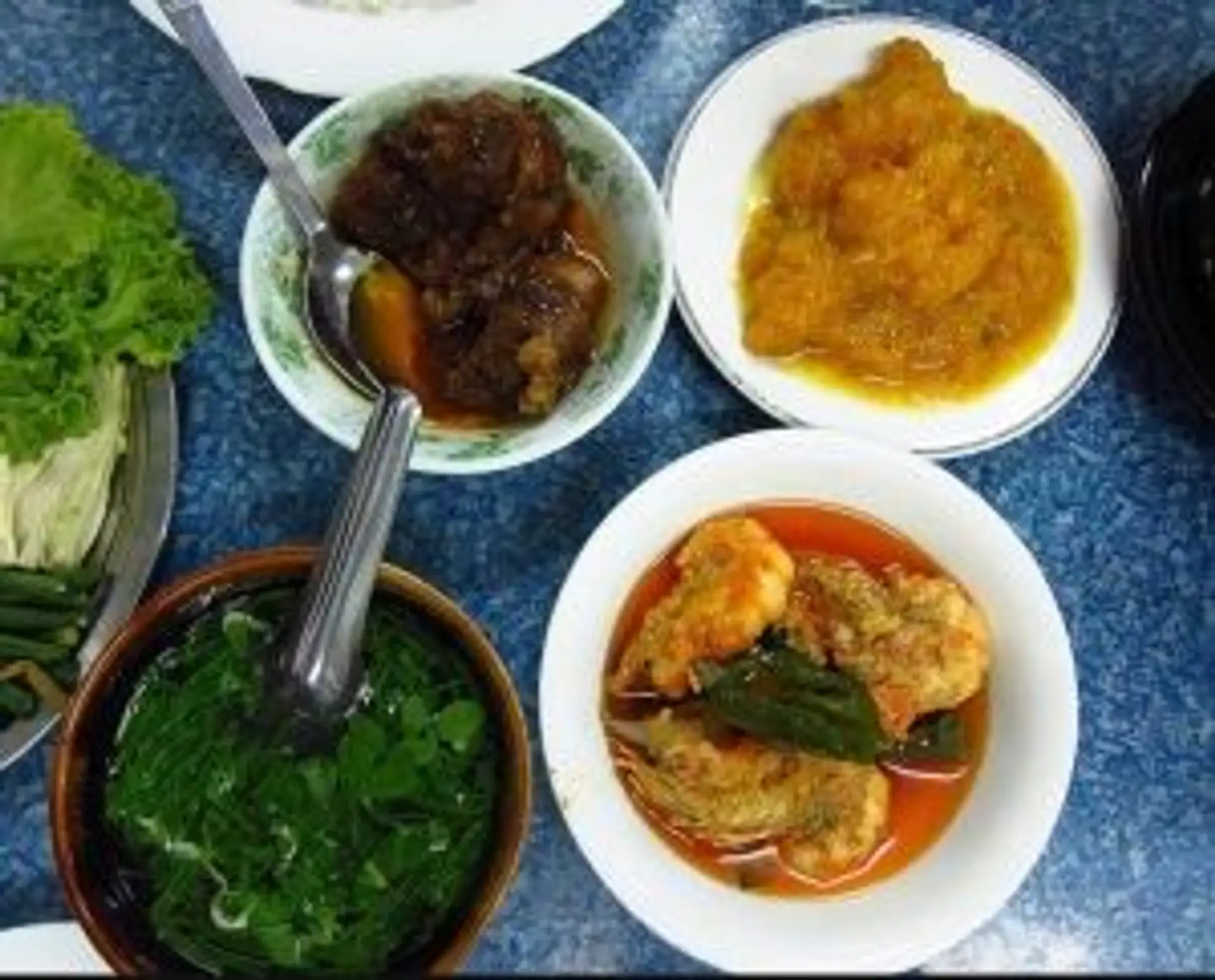 Travel in Asia - An assortment of dishes of Burmese cuisine on a table.