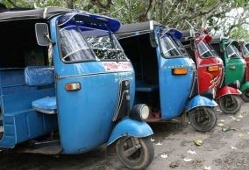 Travel in Asia - A row of parked auto rickshaws, or tuk-tuks, in Sri Lankan city