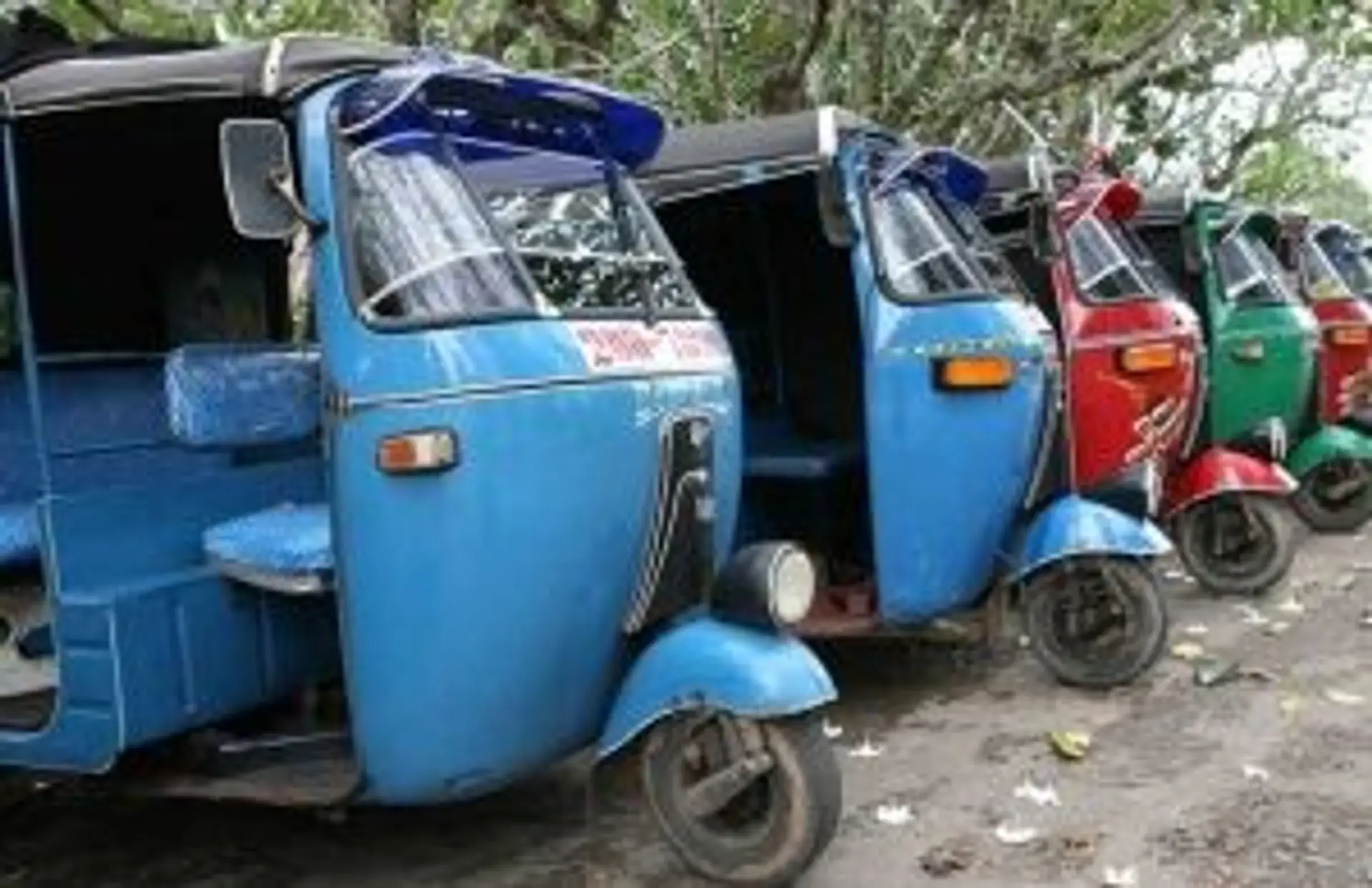 Travel in Asia - A row of parked auto rickshaws, or tuk-tuks, in Sri Lankan city