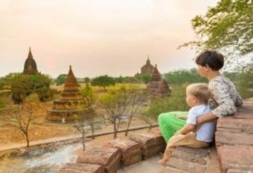Travel in Asia - A mother and child viewing the sunset over the ancient city of Bagan, Myanmar.