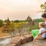 Travel in Asia - A mother and child viewing the sunset over the ancient city of Bagan, Myanmar.