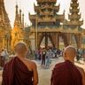 Travel in Asia - Two bald monks walking in front of Shwedagon Pagoda in Myanmar.