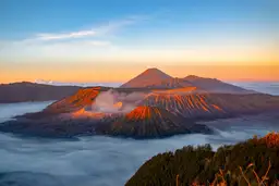 Travel in Asia - An aerial view of Mount Bromo rising above a sea of clouds in East Java, Indonesia