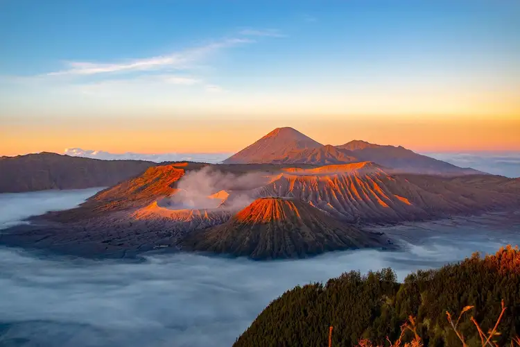 Travel in Asia - An aerial view of Mount Bromo rising above a sea of clouds in East Java, Indonesia
