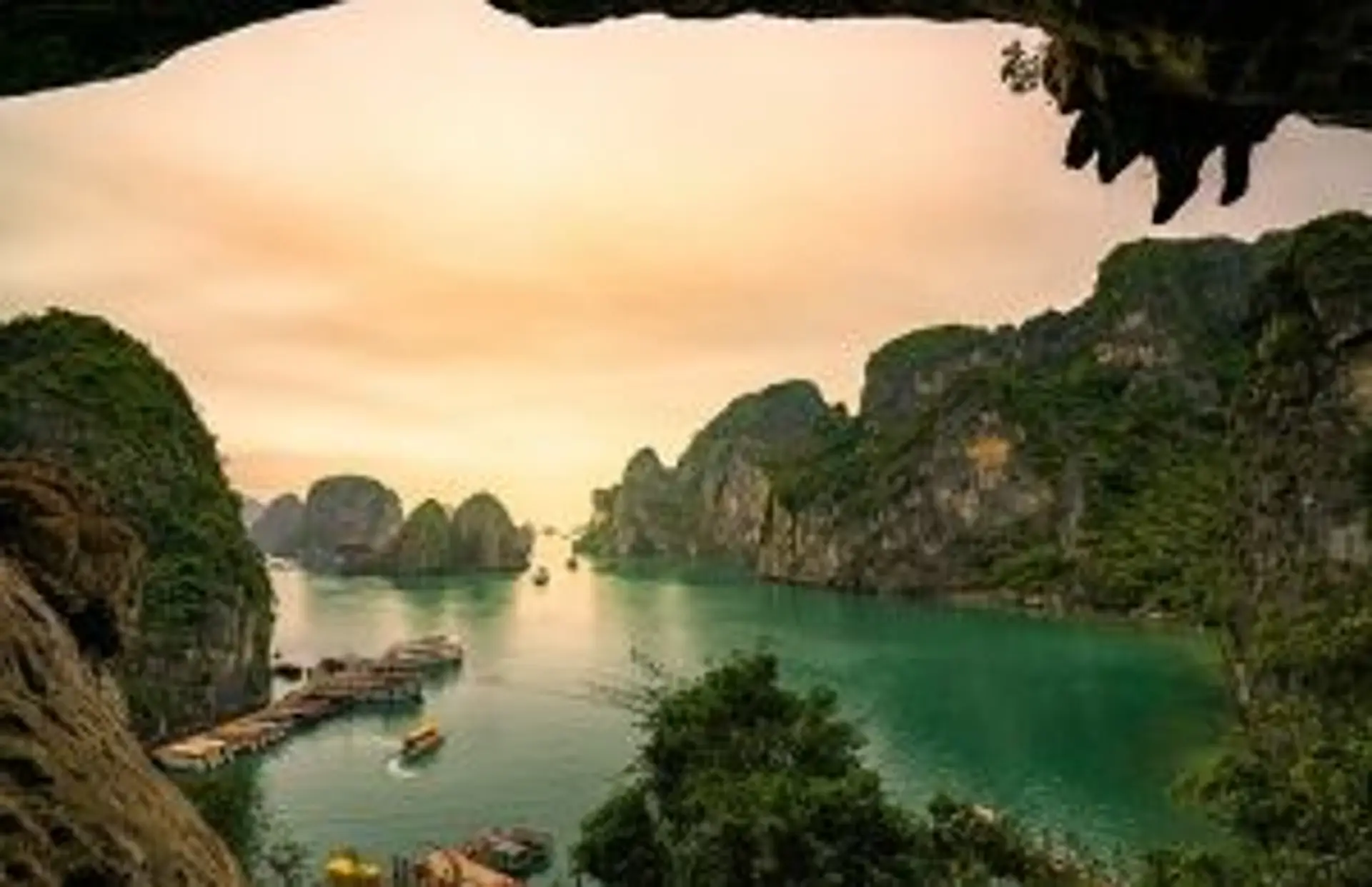 Travel in Asia - Limestone cliffs surrounding the emerald green waters of Ha Long Bay in Vietnam