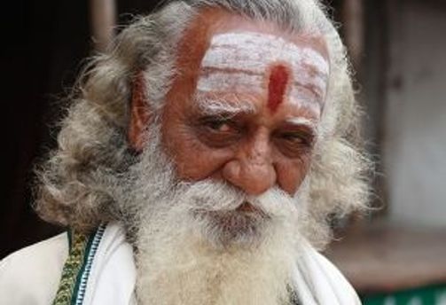 Travel in Asia - An old Indian man with a white beard and grey hair staring at the camera