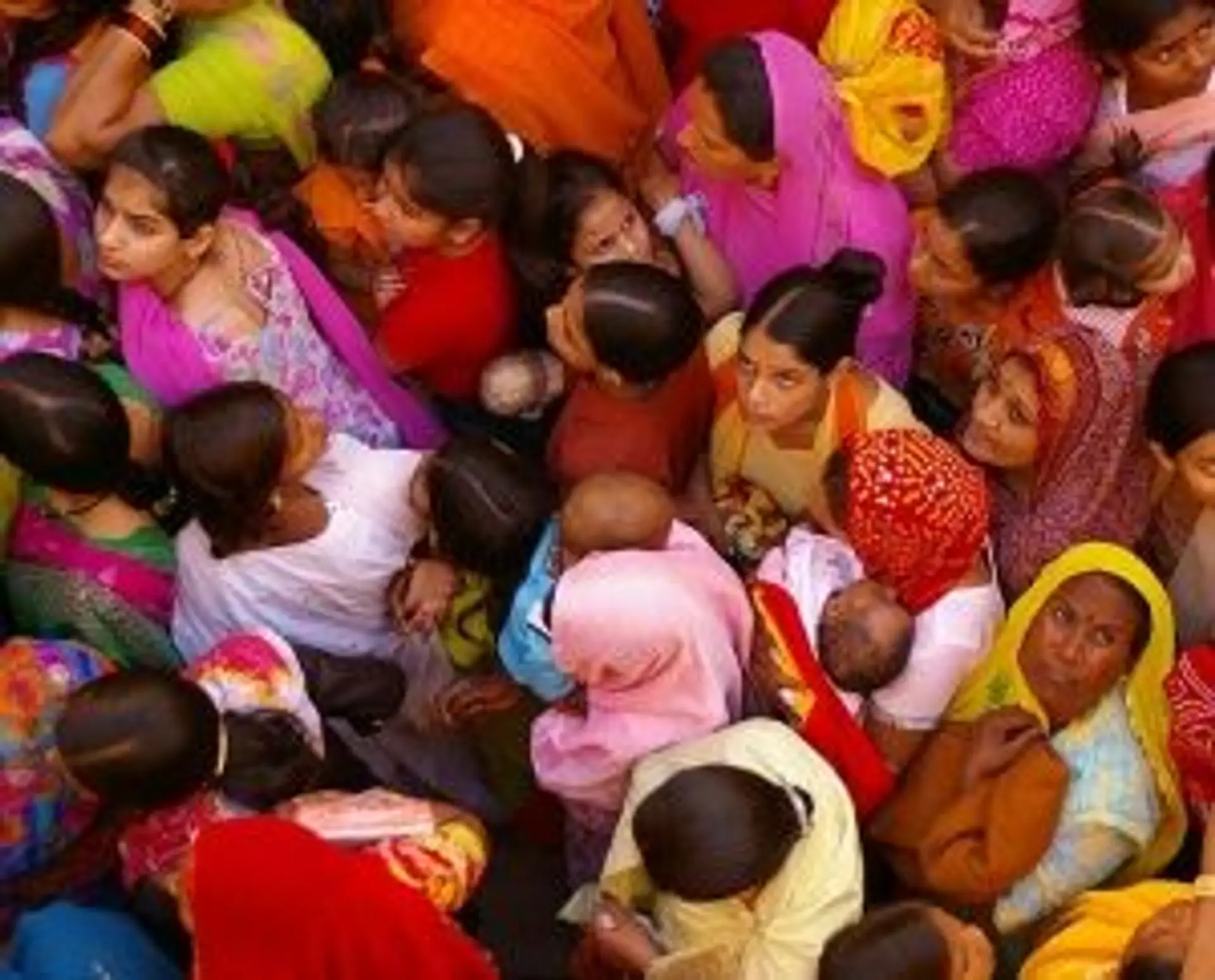 Travel in Asia - Women dressed in colorful clothing tightly crowded into the frame