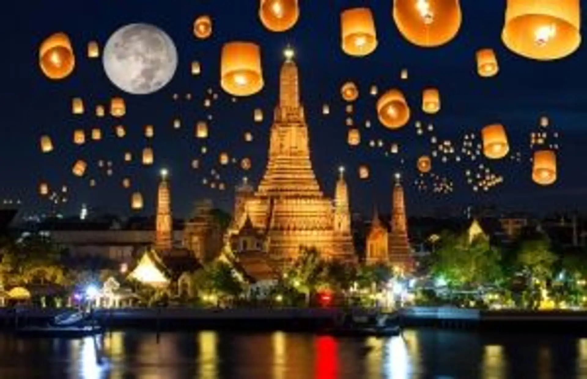 Lâcher de lanternes célestes illuminant le ciel lors du festival de Loy Krathong en Thaïlande