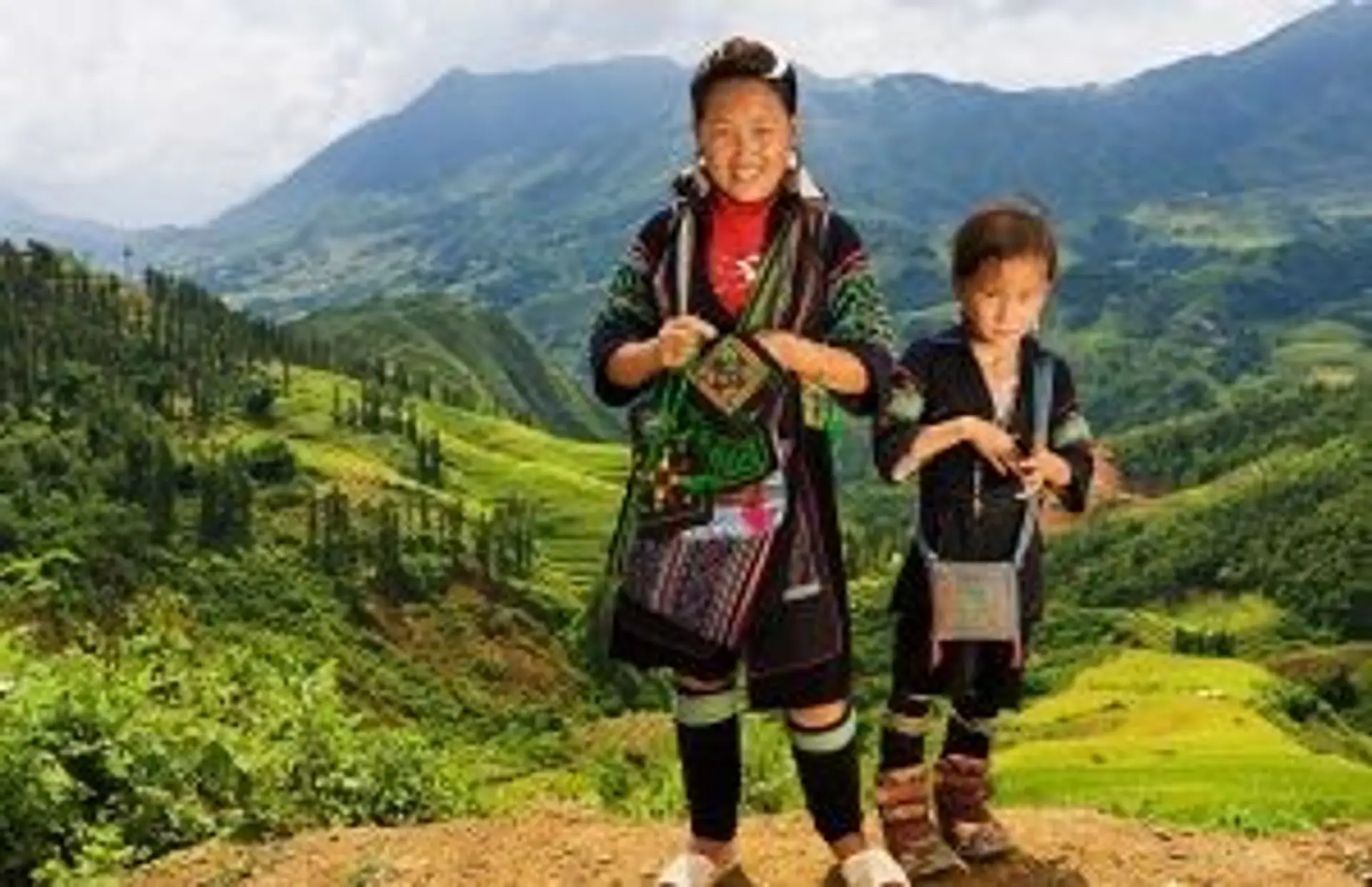 Travel in Asia - Members of the Black Hmong hill tribe standing in a mountainous landscape in Vietnam