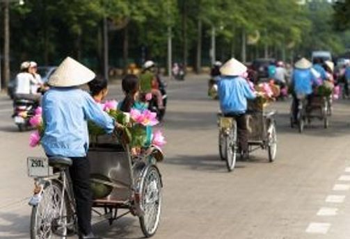 Travel in Asia - Cyclists navigating a city street in Vietnam
