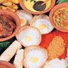 Travel in Asia - A a traditional spread of Sri Lankan cuisine, including rice, curry, and appa