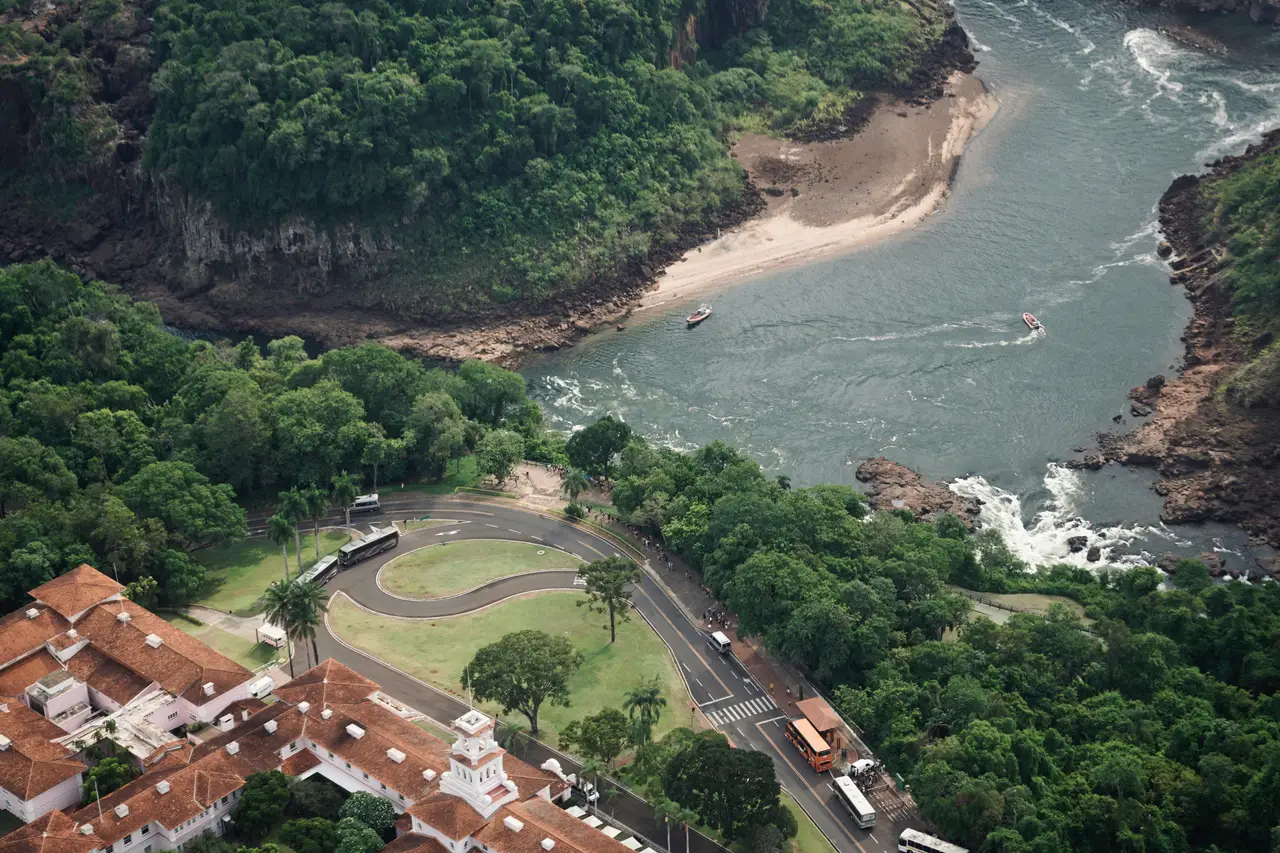Voyage au Brésil – Vue aérienne du fleuve Iguaçu serpentant au milieu de la forêt subtropicale dense lors de l'arrivée à Foz do Iguaçu.