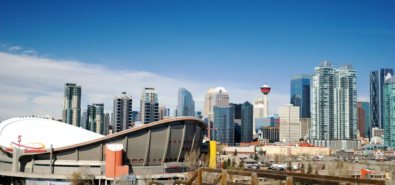 Panorama urbain des gratte-ciel du centre-ville de Calgary et du Scotiabank Saddledome sous un ciel bleu dégagé