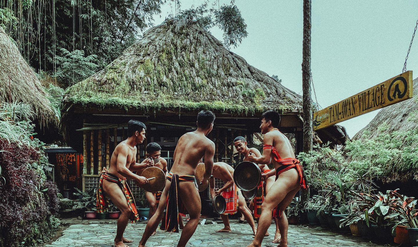 Travel in Asia - Shirtless men performing a traditional dance in the Philippines