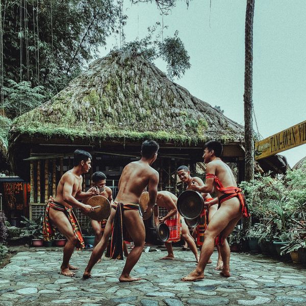Travel in Asia - Shirtless men performing a traditional dance in the Philippines