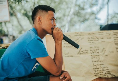 Travel in the Philippines — A Filipino man holds a microphone during a social gathering in the Visayas, illustrating the region’s strong cultural emphasis on music.