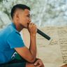 Travel in the Philippines — A Filipino man holds a microphone during a social gathering in the Visayas, illustrating the region’s strong cultural emphasis on music.