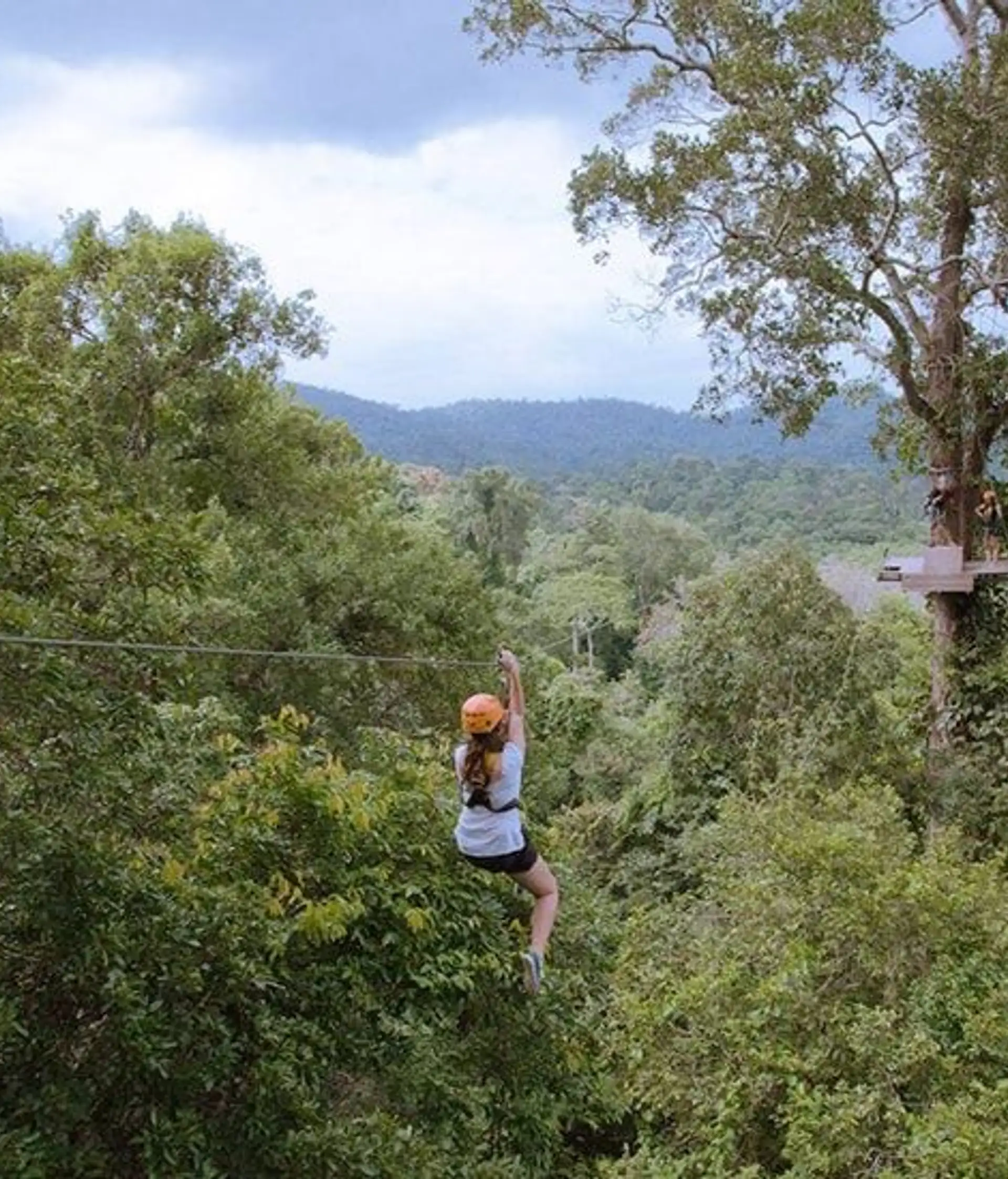 Adventure travellers zip-lining and rock-climbing near ancient Khmer temples in Cambodia – an immersive experience of nature, culture and thrills.
