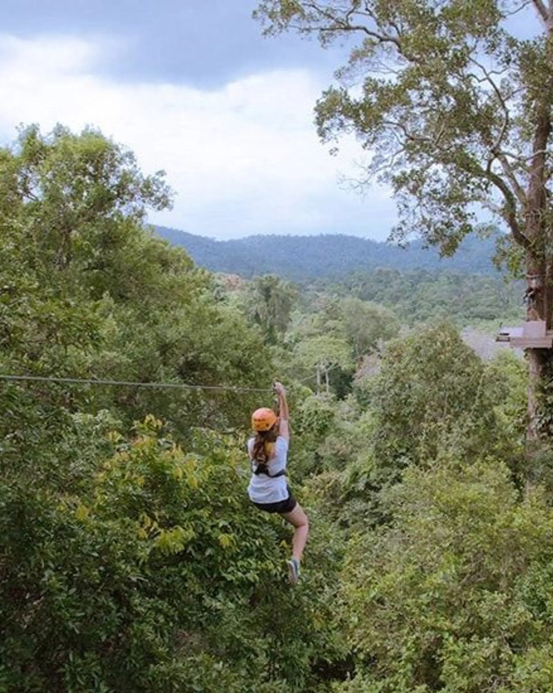 Adventure travellers zip-lining and rock-climbing near ancient Khmer temples in Cambodia – an immersive experience of nature, culture and thrills.