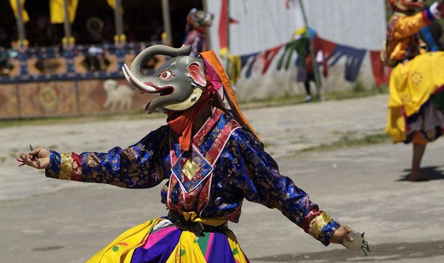Travel in Asia - Masked monks dancing in a traditional Tshechu religious festival in Bhutan 