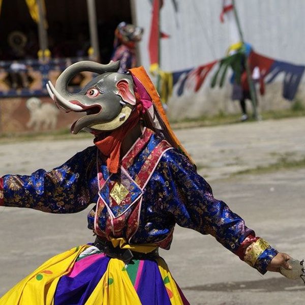 Travel in Asia - Masked monks dancing in a traditional Tshechu religious festival in Bhutan 