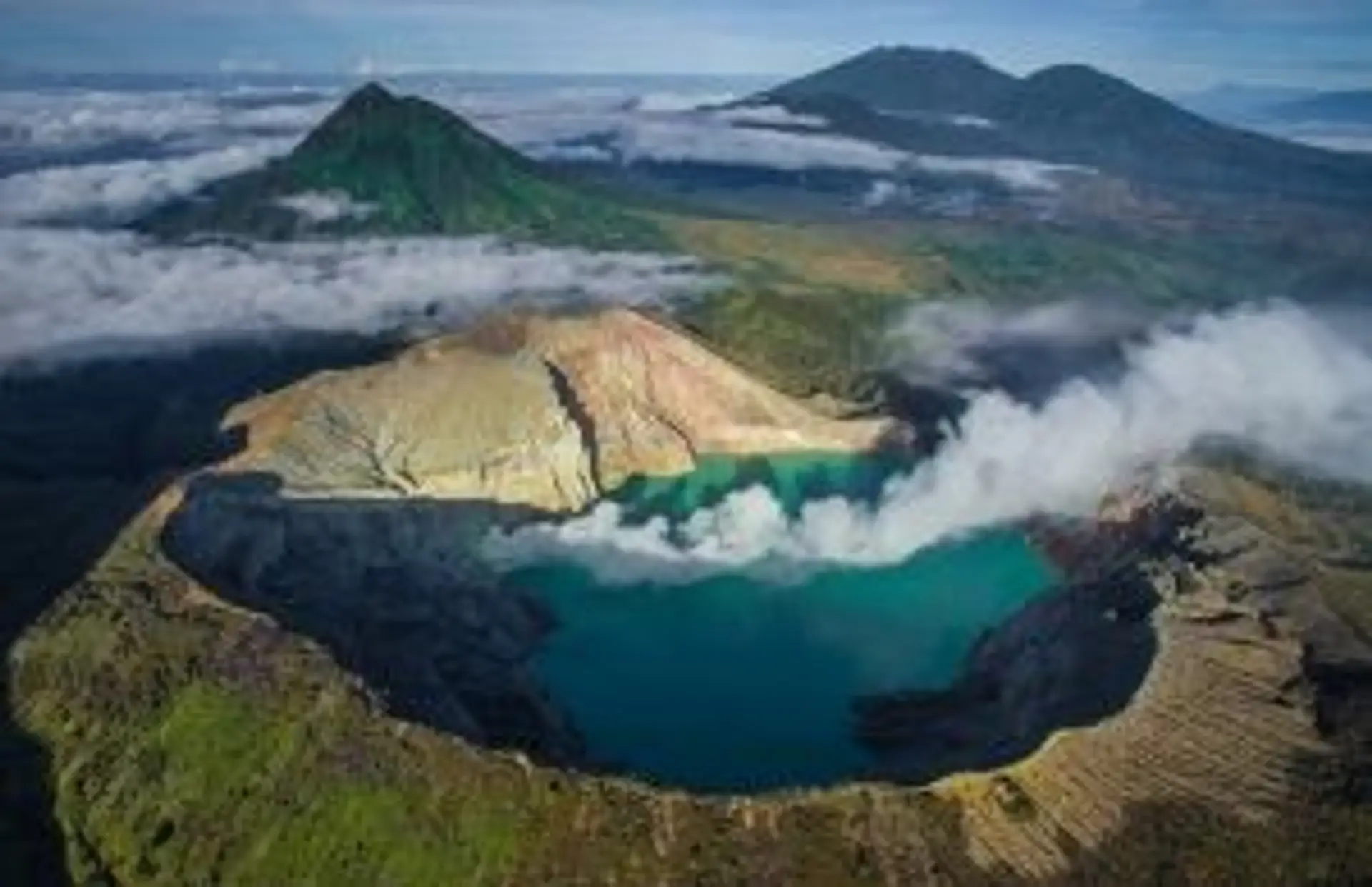 Travel in Asia - Aerial view of the smoking volcanic Ijen crater