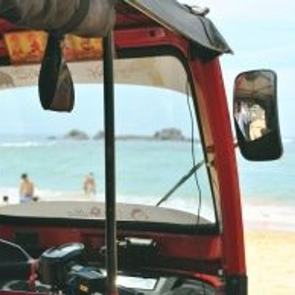 Travel in Asia - A tuk tuk waiting at a sunny golden sand beach in South Sri Lanka