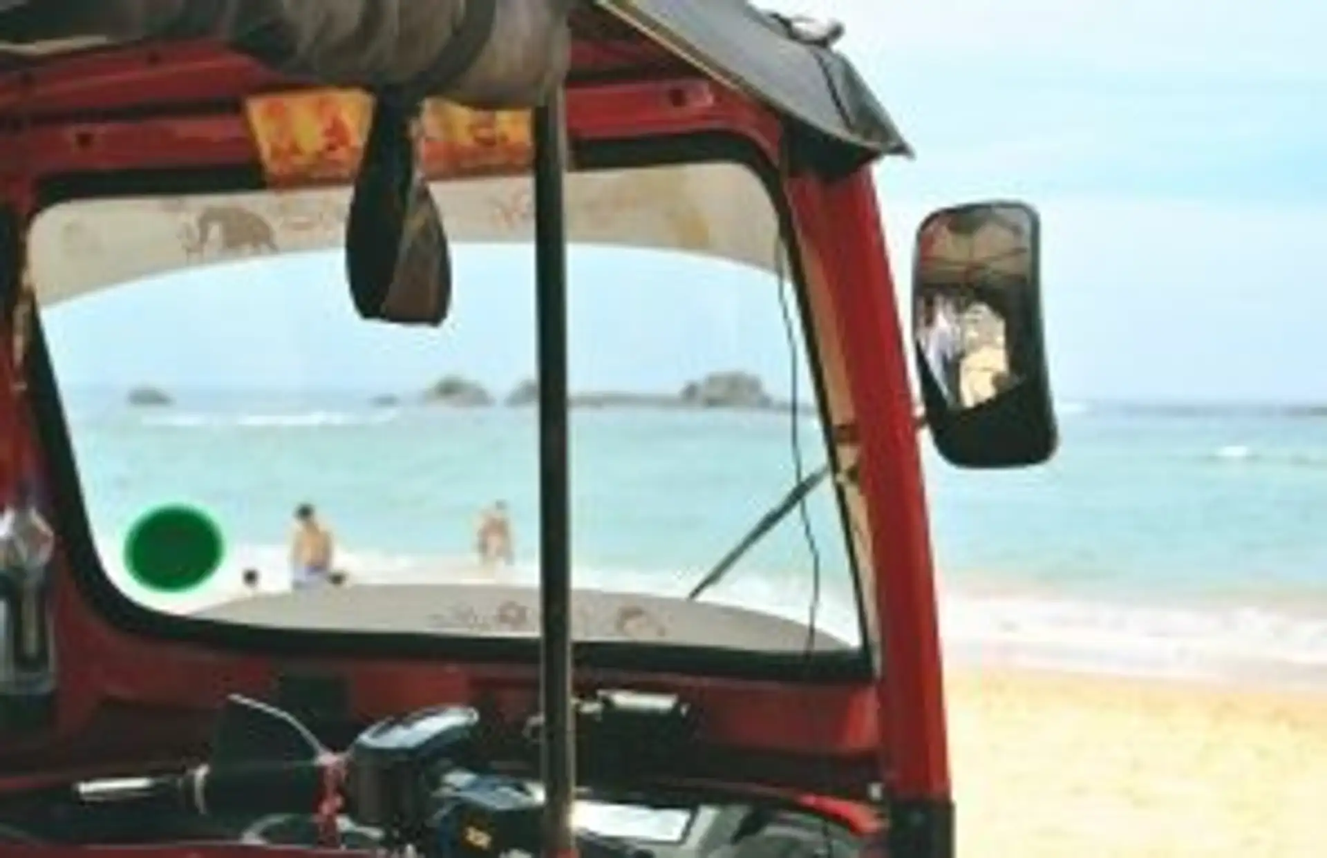 Travel in Asia - A tuk tuk waiting at a sunny golden sand beach in South Sri Lanka