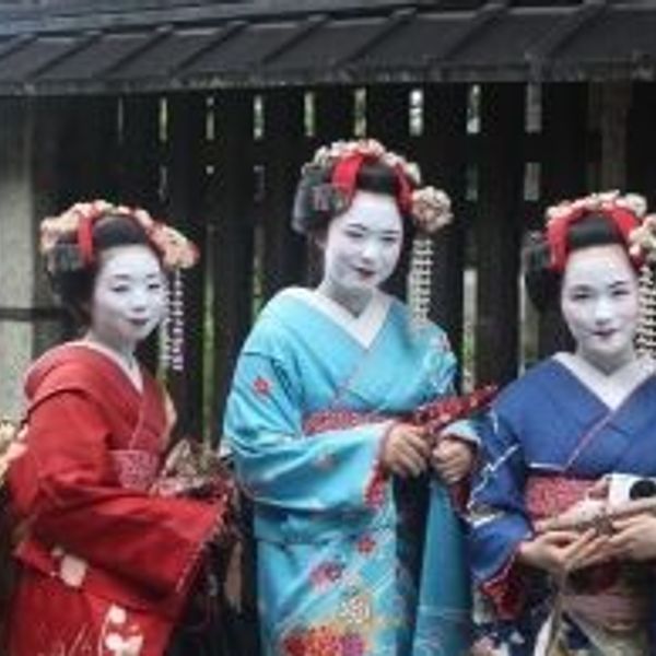 Travel in Asia - Three maiko standing for a picture in full makeup and kimono in Kyoto