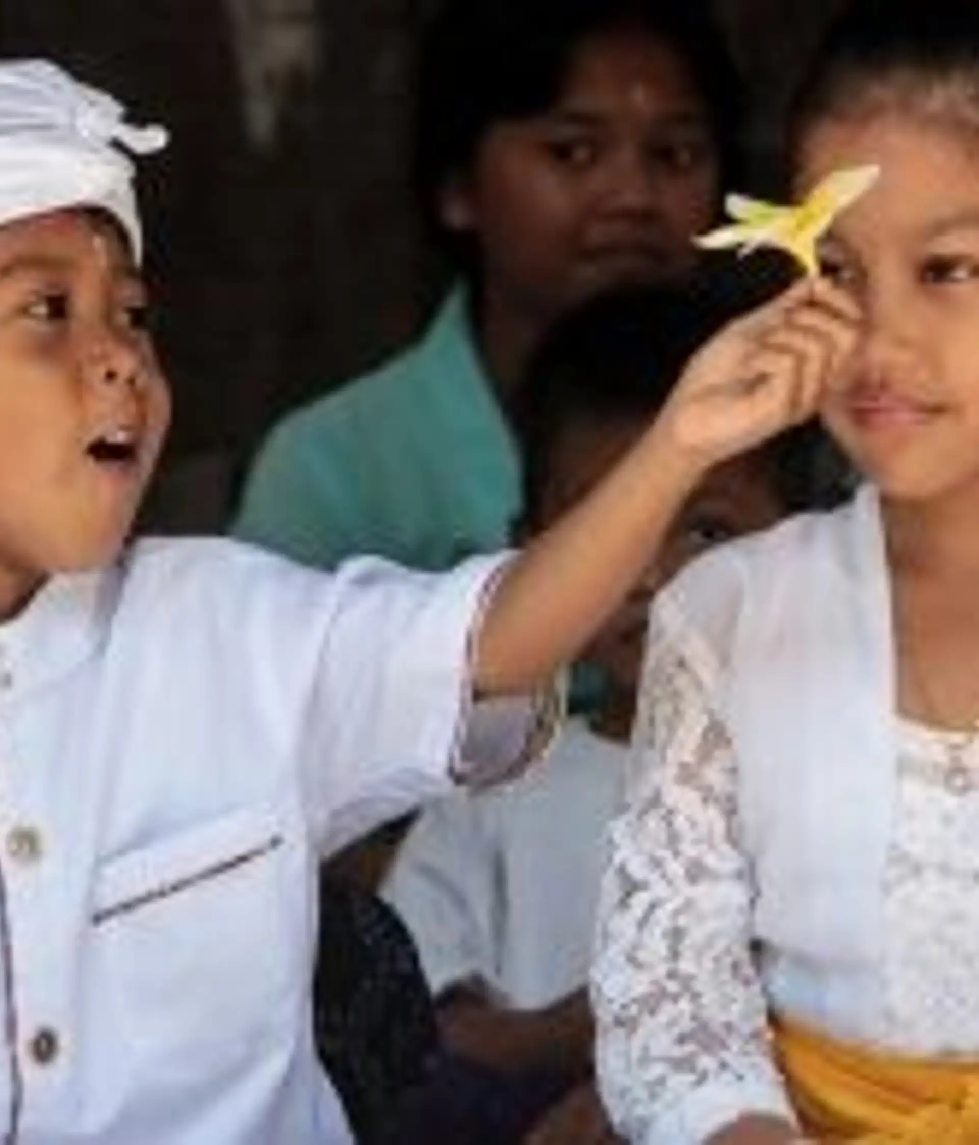 Travel in Asia - Two children in traditional white clothing during a ceremony in Bali, Indonesia