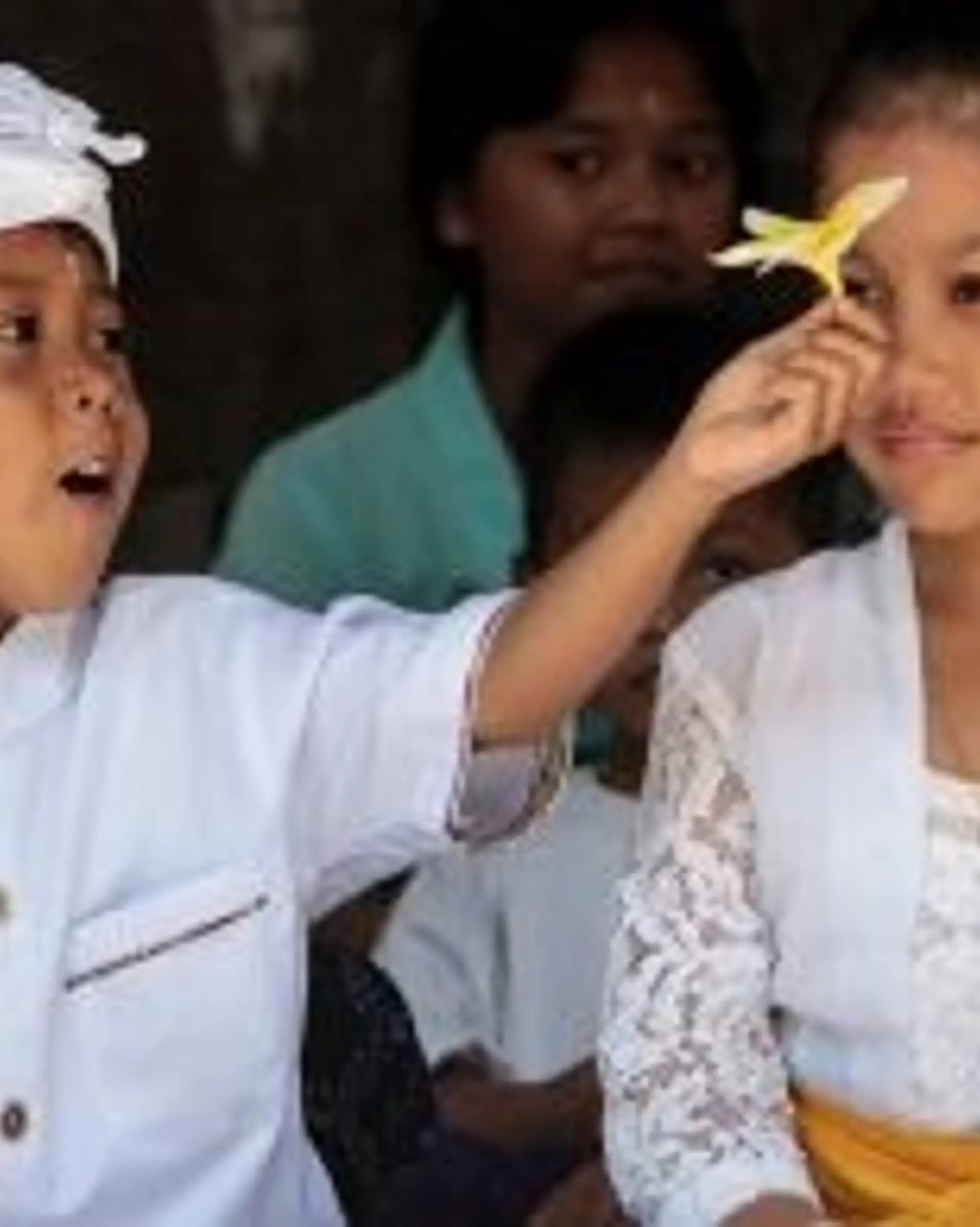 Travel in Asia - Two children in traditional white clothing during a ceremony in Bali, Indonesia