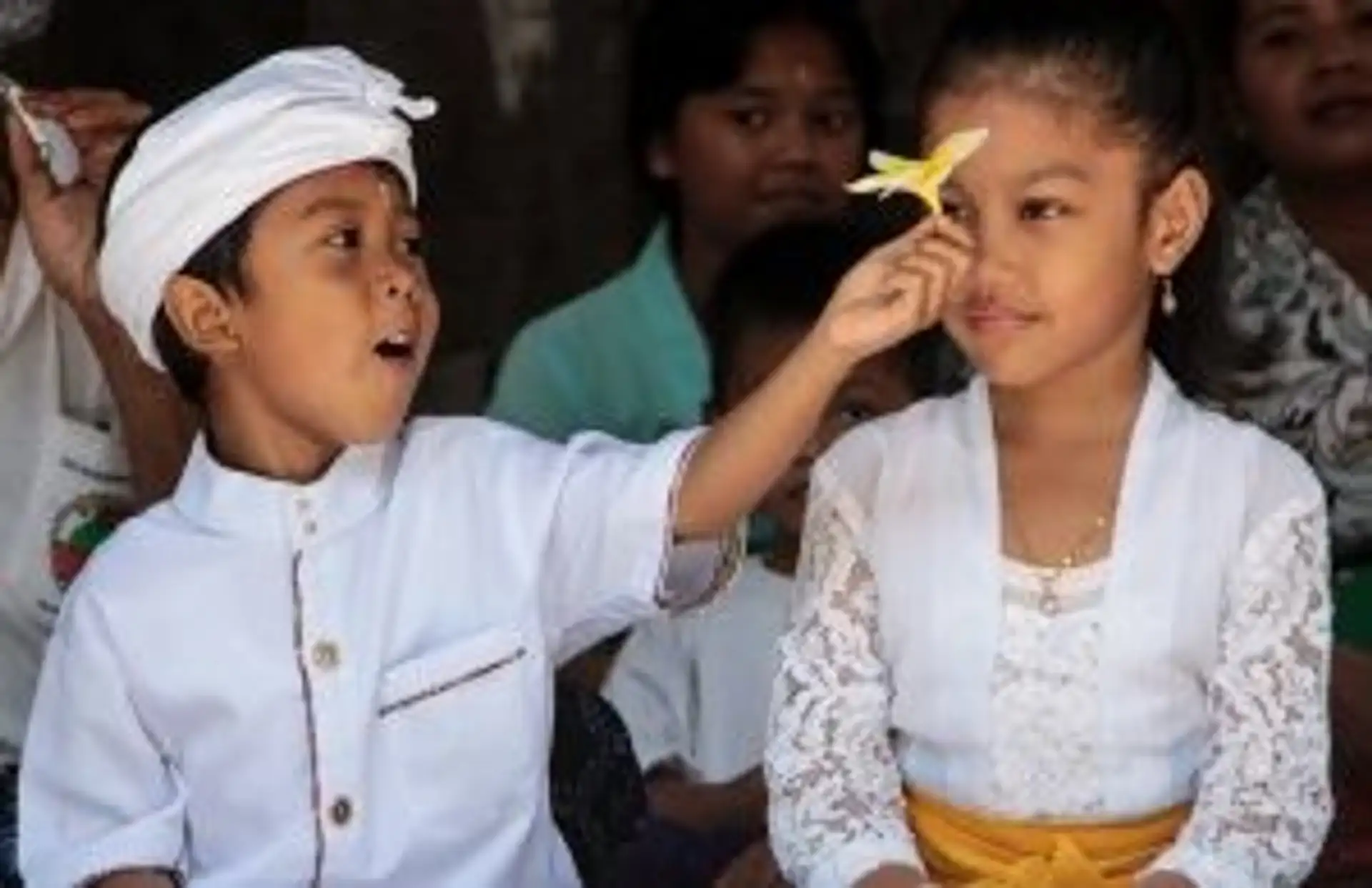 Travel in Asia - Two children in traditional white clothing during a ceremony in Bali, Indonesia
