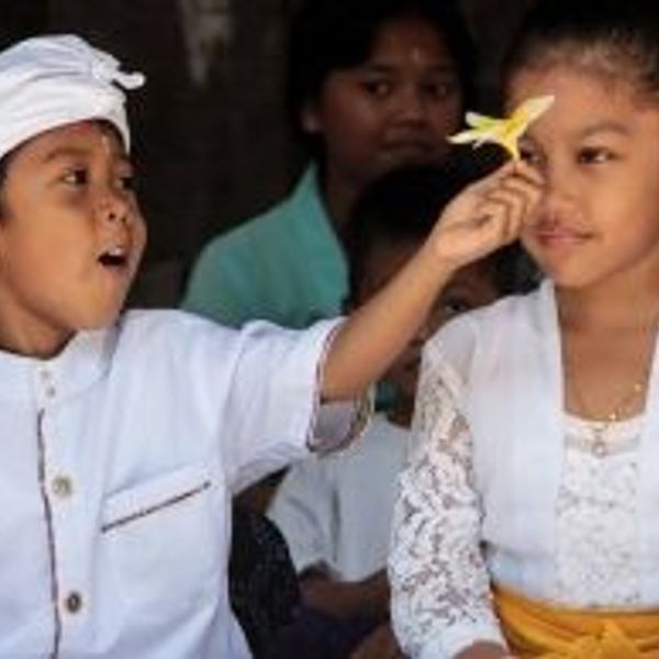 Travel in Asia - Two children in traditional white clothing during a ceremony in Bali, Indonesia