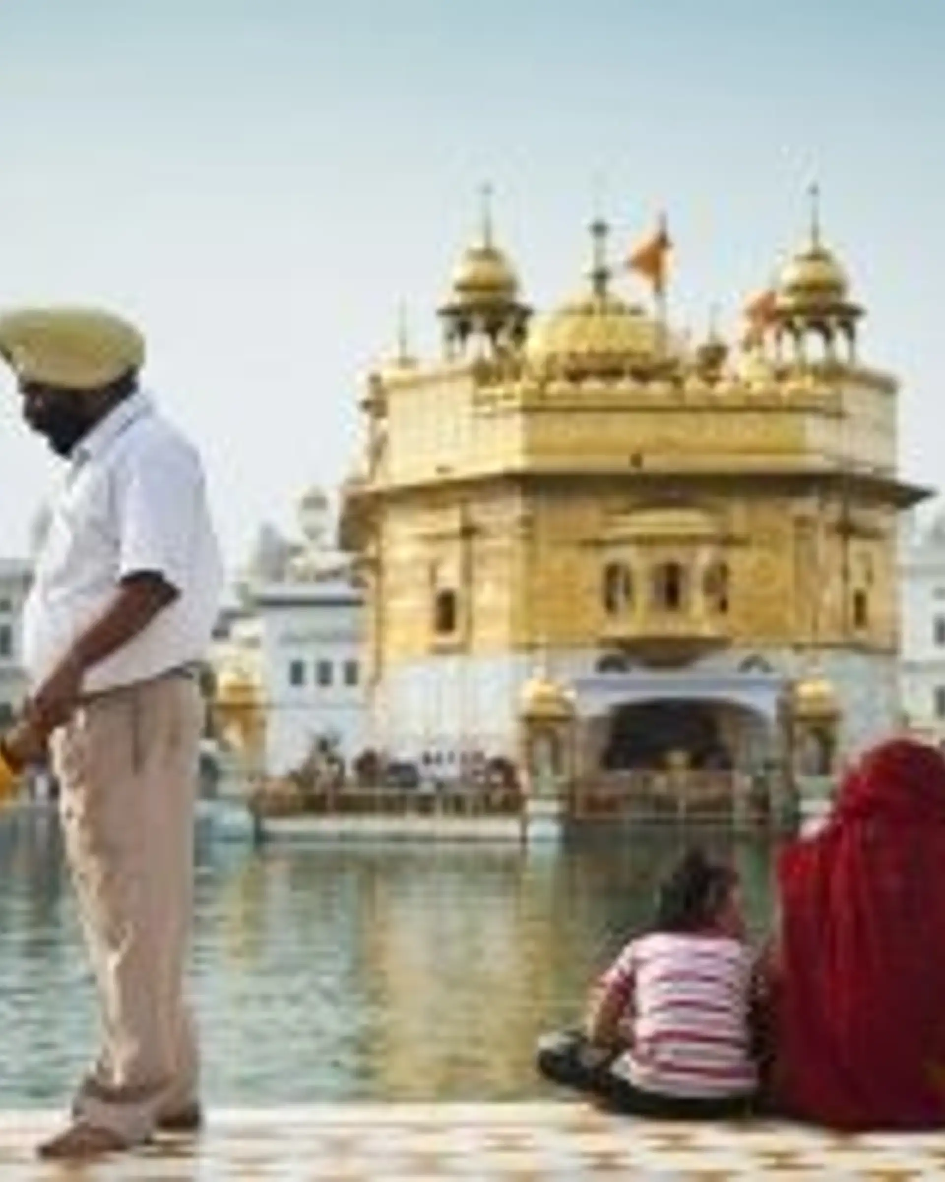 Travel in Asia - Visitors in front of the Sri Harmandir Sahib, or Golden Temple, in Amritsar, Punjab, India