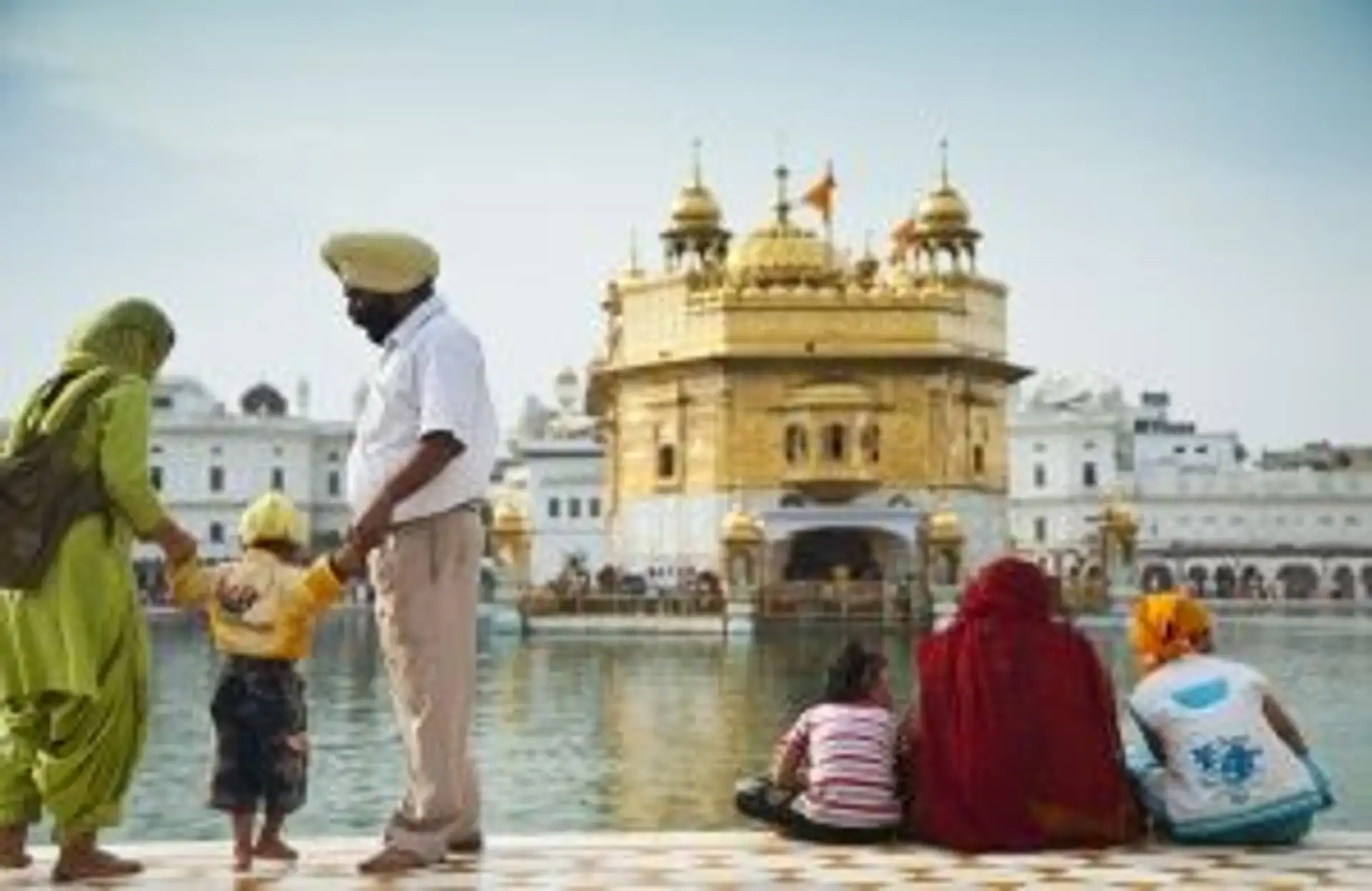 Travel in Asia - Visitors in front of the Sri Harmandir Sahib, or Golden Temple, in Amritsar, Punjab, India