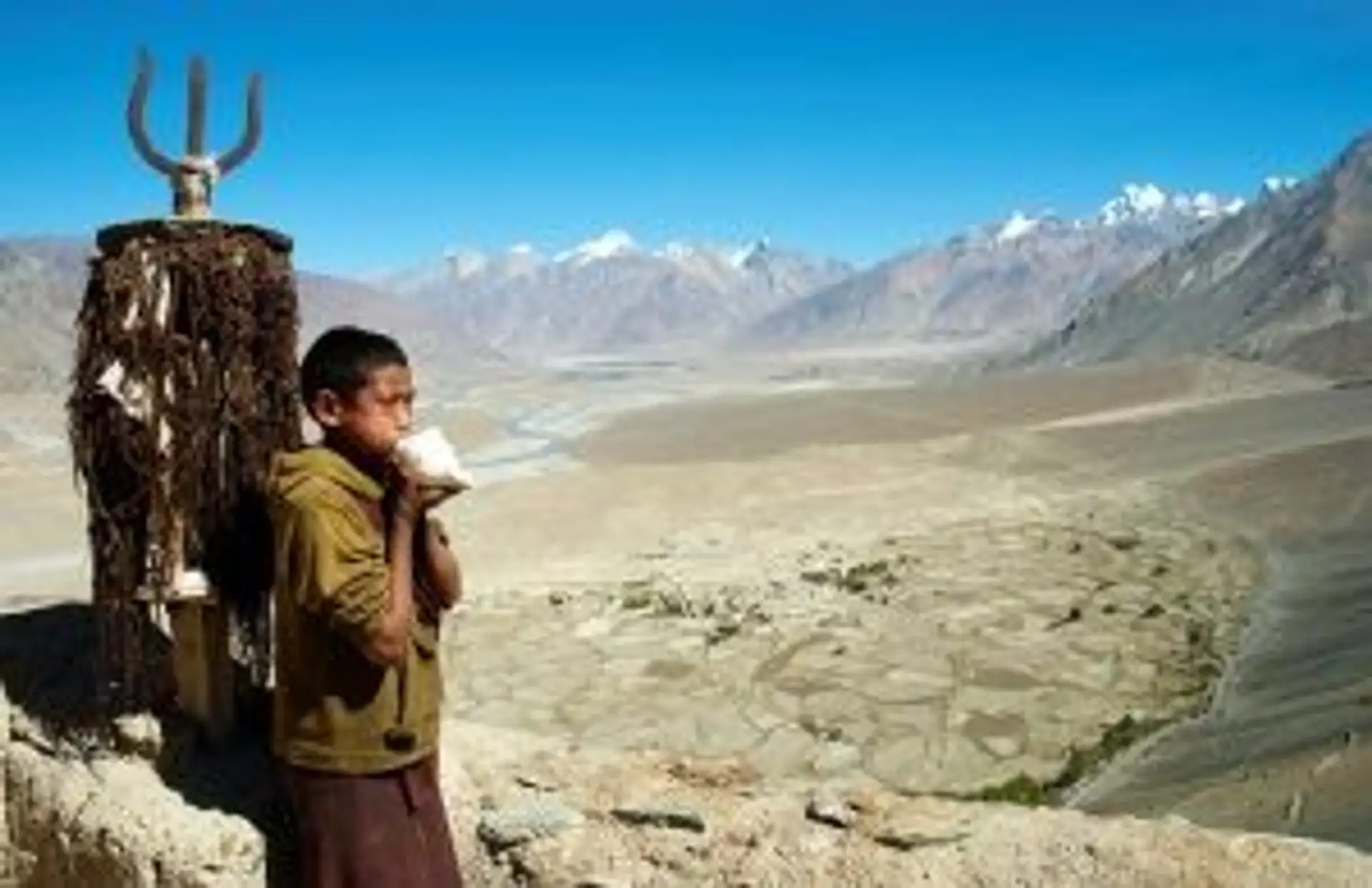 Travel in Asia - A young boy standing in front of the vast highlands near the Karsha Gompa monastery in Zanskar, Ladakh in India